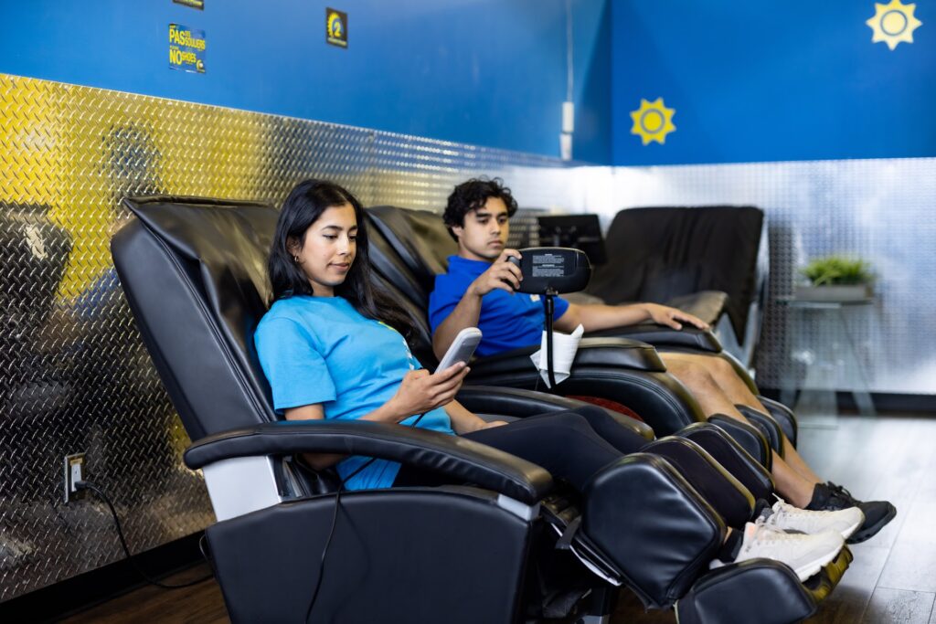 Members relaxing in Buzzfit massage chairs